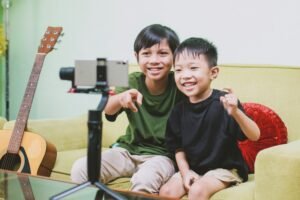 Two asian boys using smartphone for live streaming